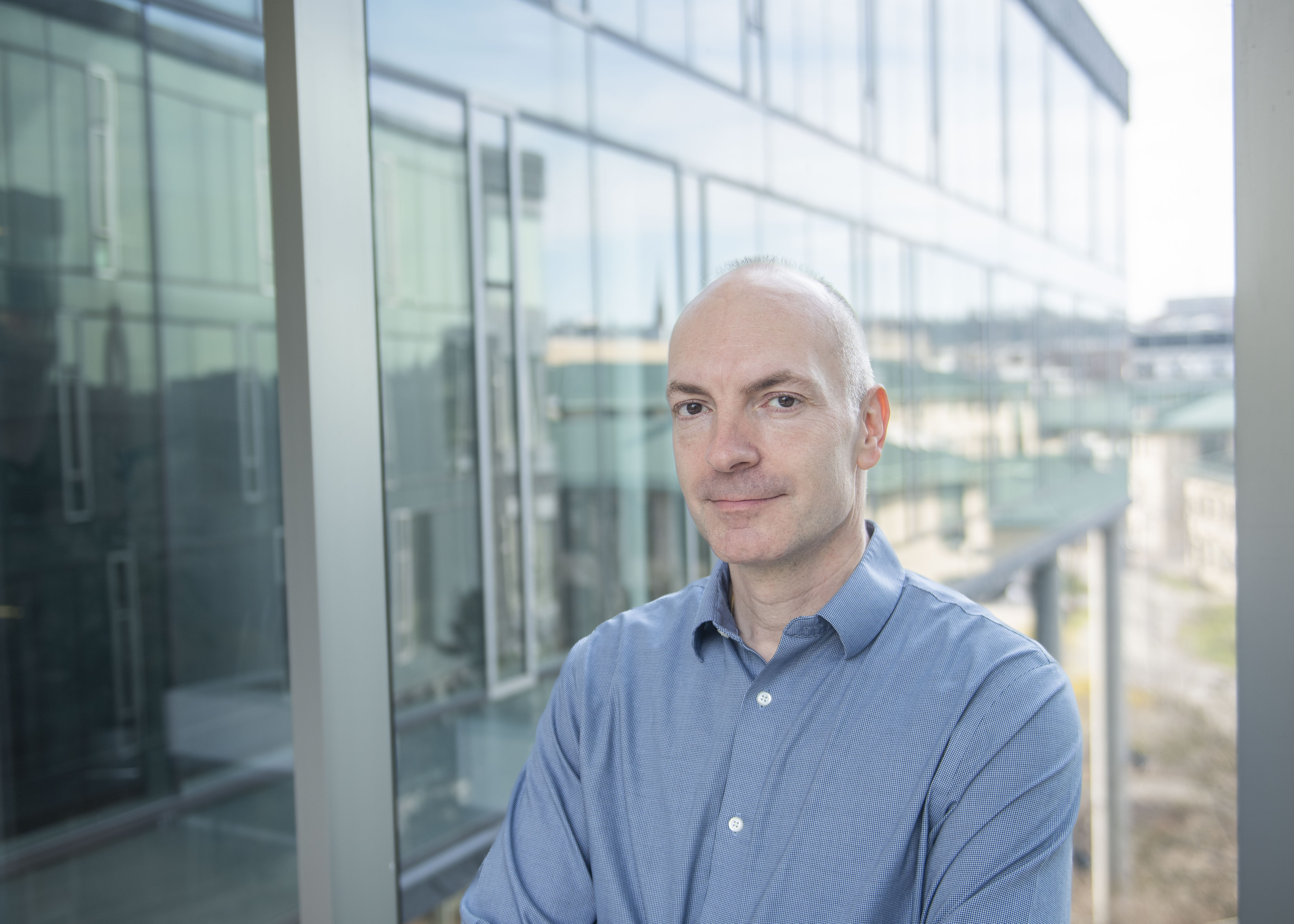 professor Nicolas Cristin, blue shirt, glass background by window